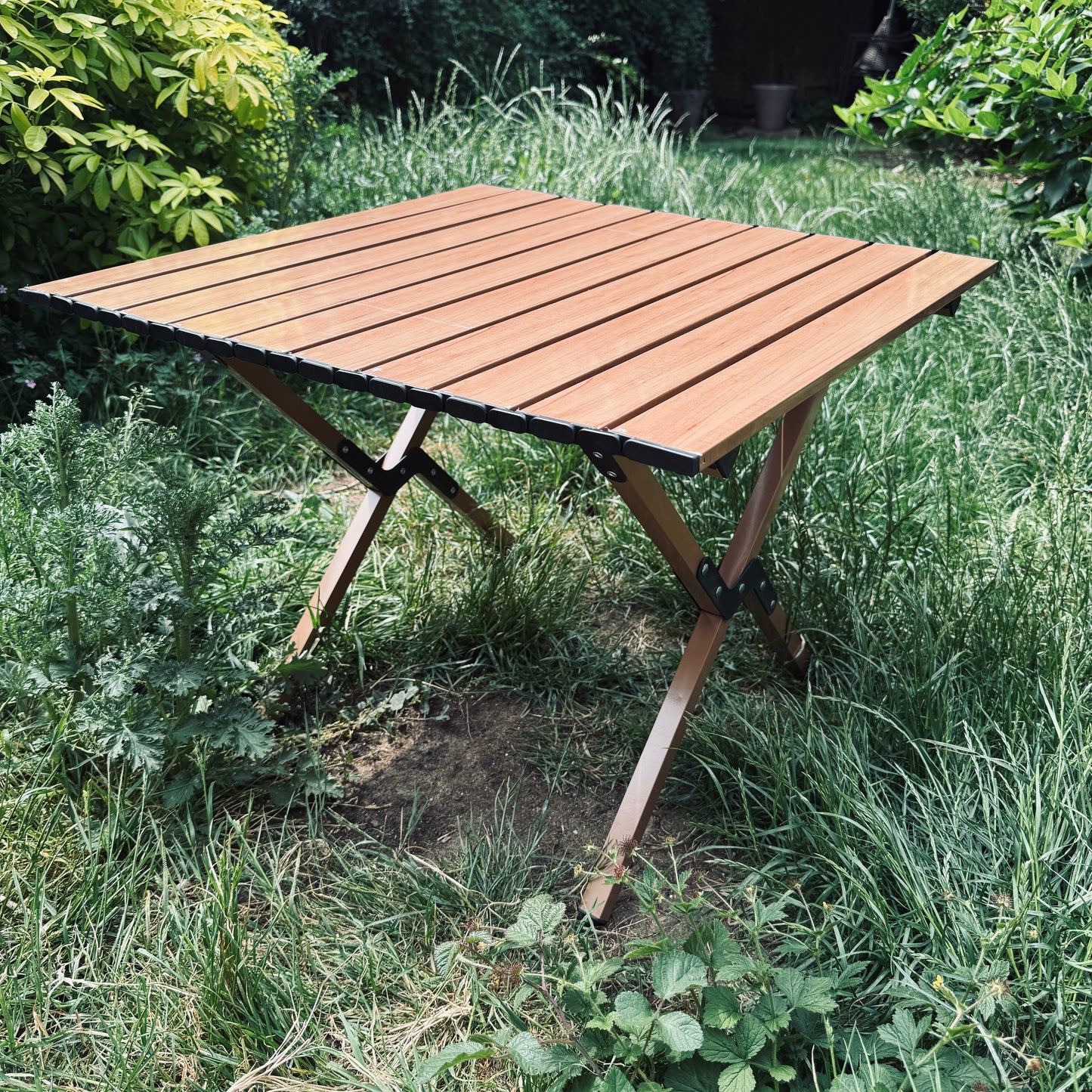 Ultra Ultra Light folding table with a Beech wood grain effect top