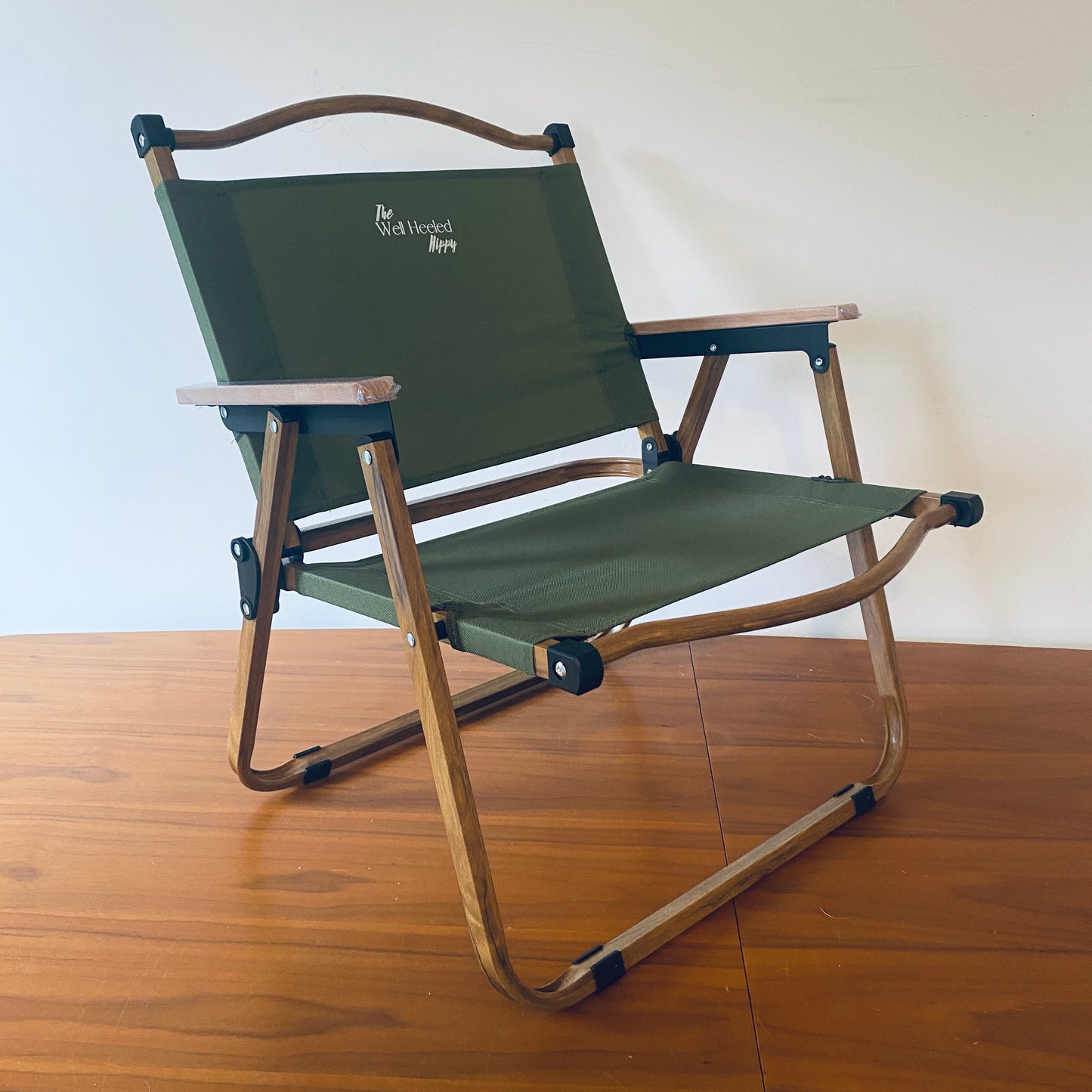 A foldable, portable, luxury safari chair by The Well Heeled Hippy - perfect for patio, festivals, camping and picnicking... shown here in khaki green